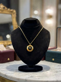 Elegant Gold-Tone Round Pendant Necklace with Black Center Design