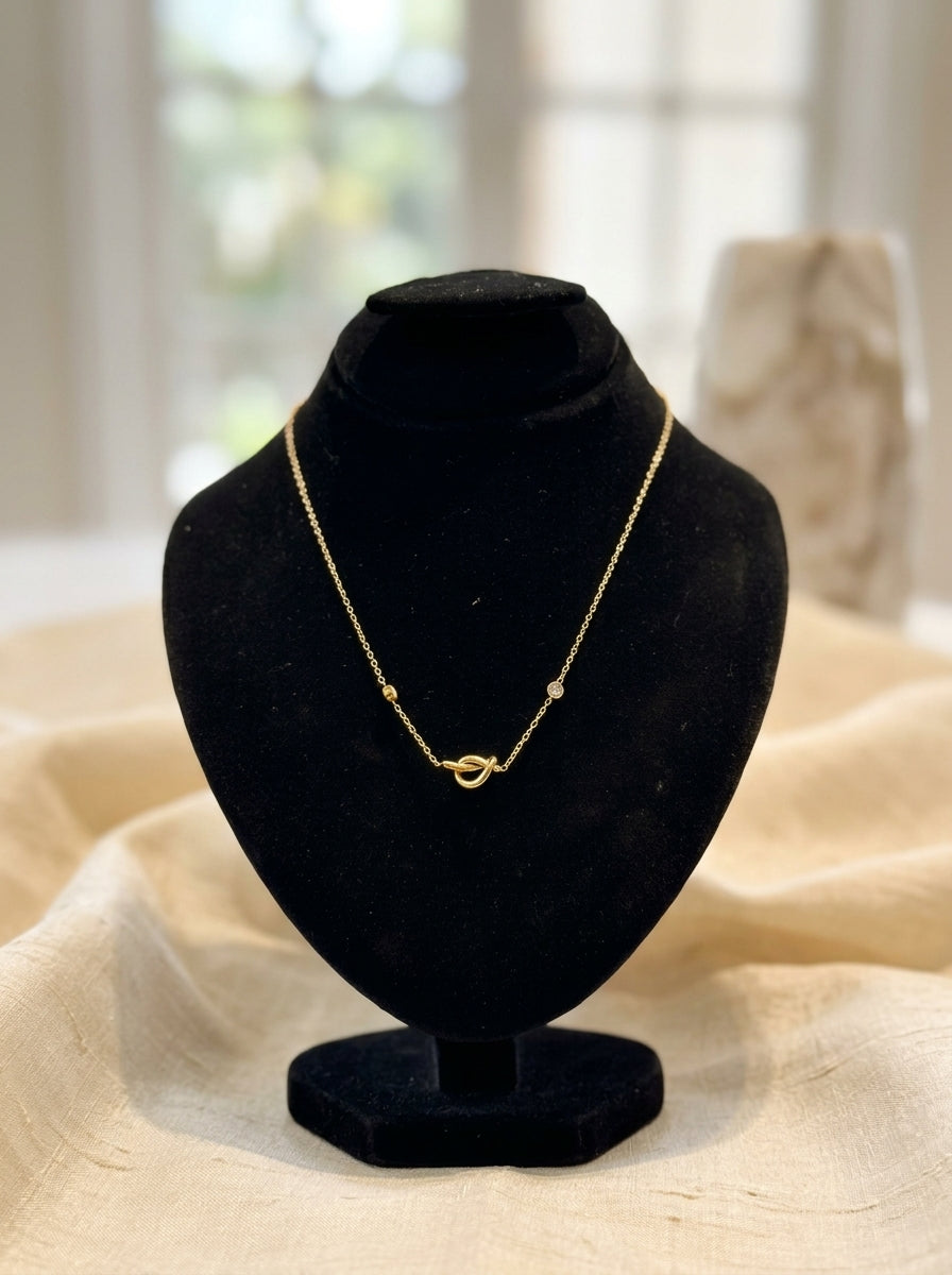 Elegant Gold-Tone Knot Necklace with Delicate Stone Accents