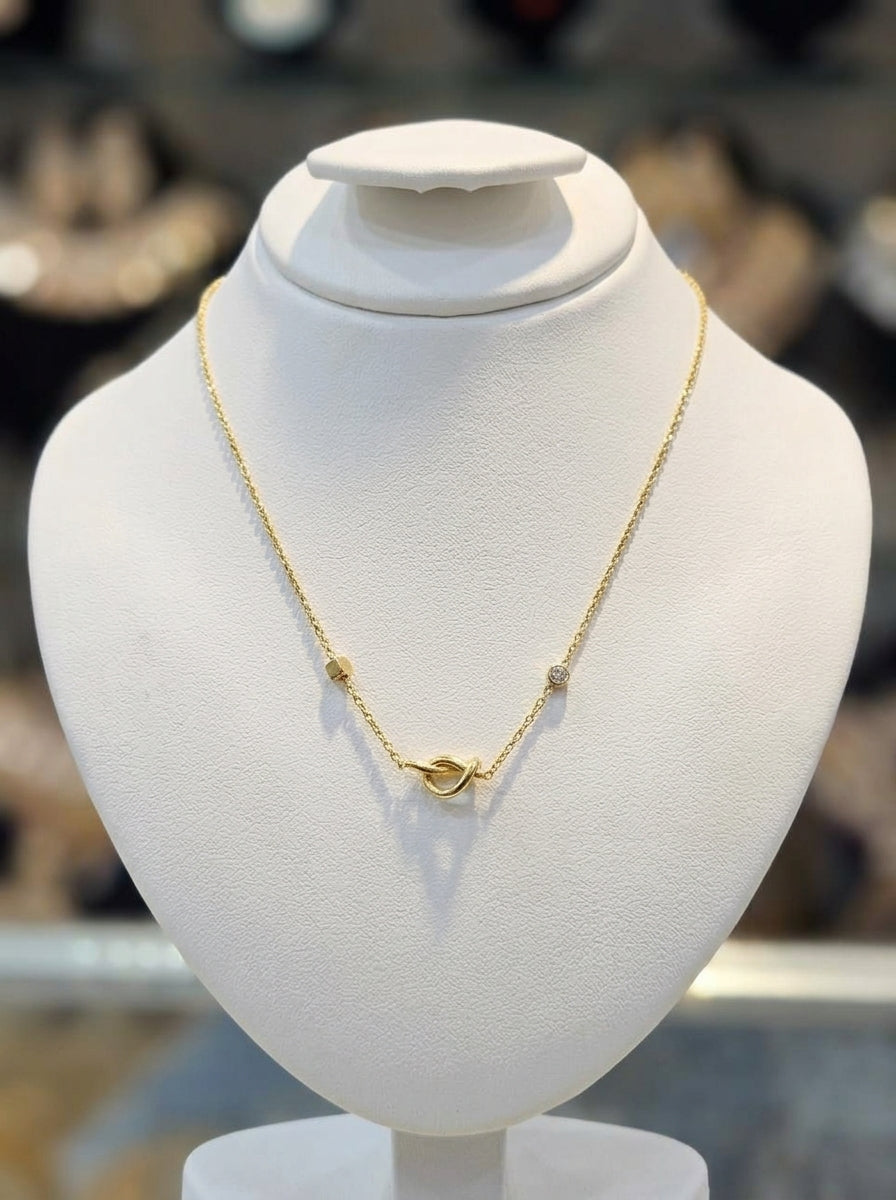 Elegant Gold-Tone Knot Necklace with Delicate Stone Accents